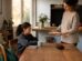 Un parent et un enfant échangeant calmement autour d’un goûter après l’école